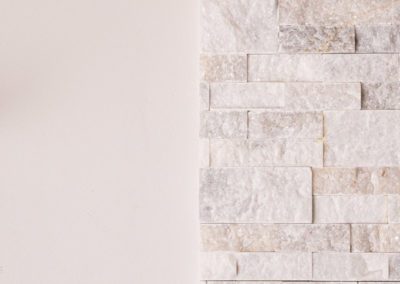 White Marble Stacked Stone Fireplace Remodel